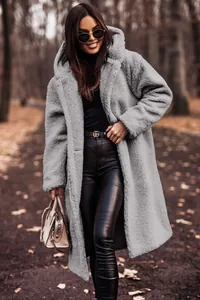 Full-length outdoor shot of a woman wearing a stylish grey plush hooded teddy coat