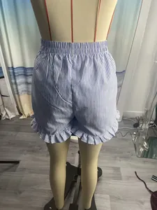 Detailed back view of women's blue and white striped shorts with ruffle hem detail