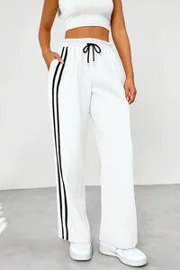 Women's high-waist wide-leg white sweatpants featuring dual black side stripes and drawstring