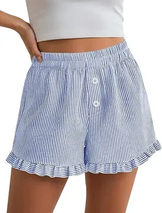 Detail shot of striped Y2K ruffle home shorts featuring cute white buttons and frilled hem.