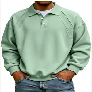 Close-up of men's sage green polo sweatshirt showing ribbed shoulder detail and buttons