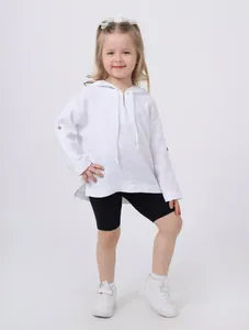 Detailed view of a girl wearing a white lightweight cotton linen hooded top with split hem