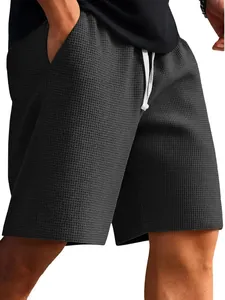 Close-up detail of men's dark gray waffle knit shorts with adjustable drawstring waist