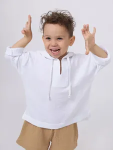 Detail shot of a white breathable cotton linen hooded shirt for kids with soft fabric