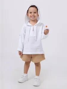 Toddler boy wearing a white hooded cotton linen shirt and tan shorts holding a lollipop