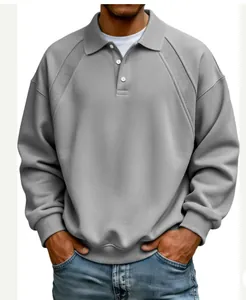 Detailed view of a men's grey polo sweatshirt with ribbed shoulder panels and buttons.