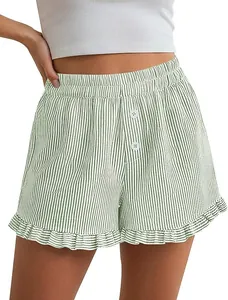 Close-up of green striped Y2K loungewear shorts with ruffle hem and button detail