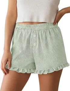 Close-up of green vertical striped pajama shorts with feminine ruffle hem and buttons