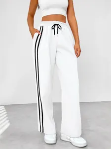 Women's high-waist white wide-leg sweatpants with black side stripes and drawstring