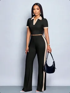 Detailed view of a stylish black and beige two-piece ribbed polo top and pants set