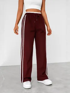 Women's burgundy wide-leg sweatpants with white side stripes and high-waist drawstring