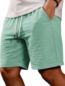 Detailed close-up view of light green textured casual shorts for men with drawstring