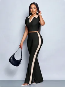 Full body view of a black two-piece set featuring a polo top and side-striped flared pants.