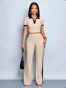 Beige two-piece set featuring slim-fit polo shirt and matching trousers with black trim