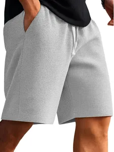 Detail view of gray waffle knit fabric texture on men's casual drawstring beach shorts.