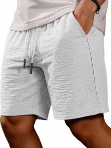 Close-up detail of the textured summer fabric and drawstring waist of gray casual shorts
