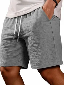Close-up detail of gray textured men's summer shorts with drawstring waist and pockets