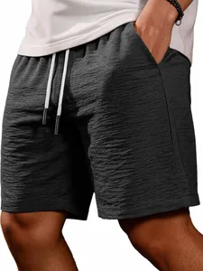 Close-up of men's dark grey casual shorts with textured fabric and drawstring.