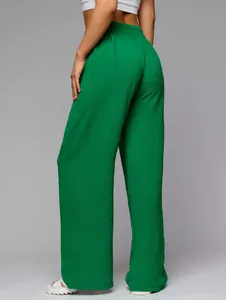 Green high-waisted wide-leg trousers with textured fabric and floor-length design