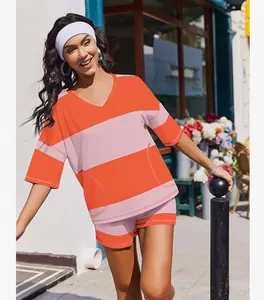Women's two-piece sports set featuring orange and pink striped V-neck top and matching shorts