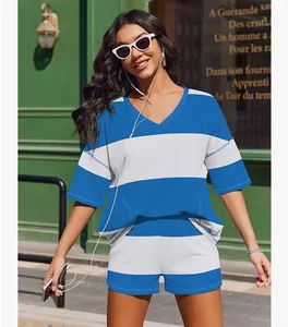 Stylish woman in a blue and white striped two-piece leisure set with top and shorts