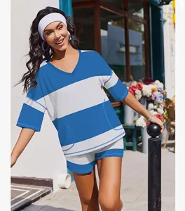 Model wearing blue and white striped two-piece casual sports set in an outdoor setting
