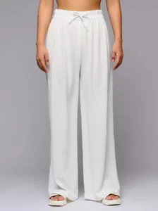 Front view detail of white high-waisted wide-leg trousers with drawstring waist