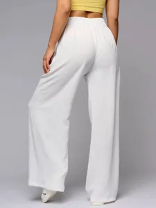 Back view of women's high waisted white wide leg pants showing drapey fabric texture