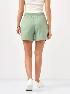 Rear view detail of women's sage green casual shorts featuring an elastic waistband