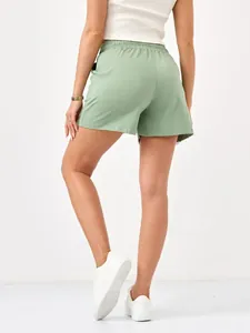 Back view of mint green women's casual shorts with comfortable elastic waistband detail