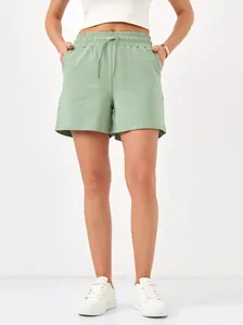 Close-up detail of women's mint green casual shorts featuring elastic waist and drawstring.