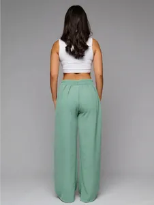 Back view of women's mint green high-waisted wide-leg trousers with elegant drape