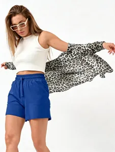 Styling of blue casual drawstring shorts with white tank top and leopard print shirt