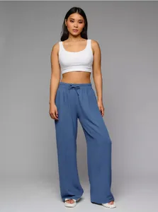 Full-length view of women's high-waisted blue wide-leg trousers in a loose fit