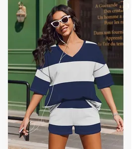 Full body view of a stylish woman wearing a blue and white striped summer short set.
