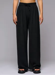 Close-up detail showing the texture and drawstring waist of black high-waisted casual pants.