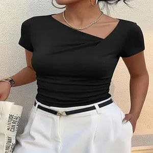 Détail d'un t-shirt noir ajusté avec décolleté asymétrique et corsage plissé