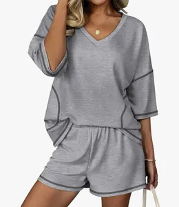 Detail view of women's gray two-piece loungewear set with V-neck top and matching shorts
