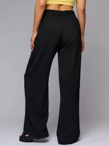 Back view of women's high-waisted black wide-leg trousers with elastic waistband