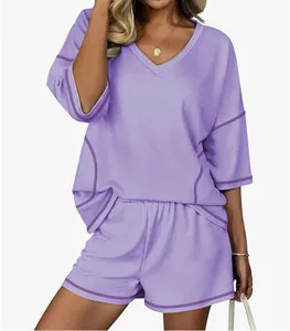 Women's stylish lavender two-piece lounge set with V-neck short sleeve top and matching shorts