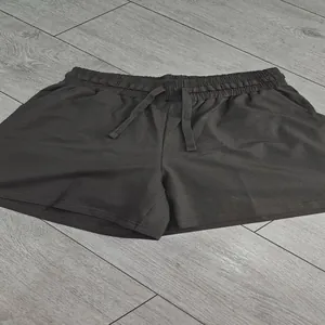 Close-up of dark gray women's casual shorts with elastic drawstring waist.