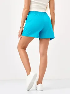 Back view of woman wearing bright blue casual sports shorts with elastic waist