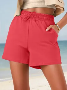 Detail showing elastic waistband and drawstring on red summer casual shorts