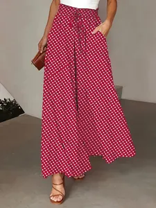 Close-up of the red bohemian wide-leg pants showing the polka dot print and elastic waist
