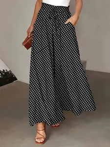 Detail of bohemian black and white polka dot wide leg palazzo pants with drawstring waist