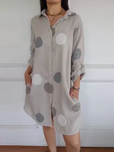 Women's elegant long-sleeved button-down shirt dress featuring a large polka dot print