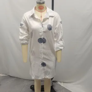 Elegant white button-down shirt dress with large grey polka dots on a mannequin.