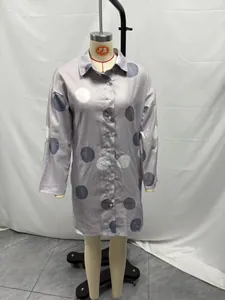 Elegant long-sleeve polka dot shirt dress with button-down front shown on a mannequin