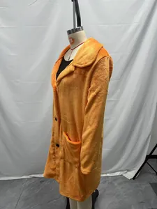 Detalle de abrigo de felpa naranja de largo medio con cuello de solapa y bolsillos