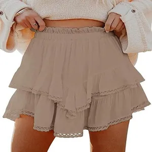 Detail showing the delicate lace hem and tiered ruffle design of the taupe mini skirt.